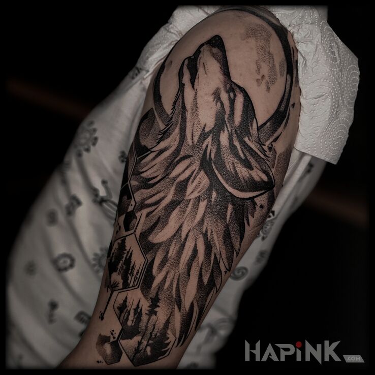 Tattoo Wolf on the shoulder in black and gray motif and dotwork style On the arm