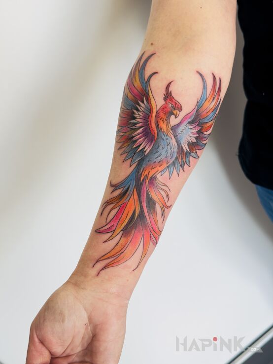 Tattoo Colorful Phoenix in fantasy motif and graphic / illustrative style On the arm