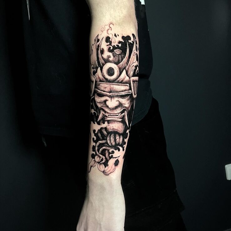 Tattoo Samurai in a mask in black and gray motif and graphic / illustrative style On the arm