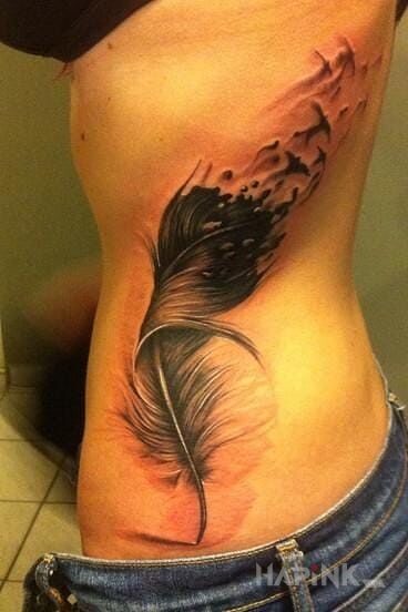 Tattoo Rozpadające się piórko in 3D motif and realistic style on the ribs