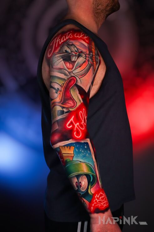 Tattoo Looney Tunes Sleeve in lettering motif and newschool style on the forearm