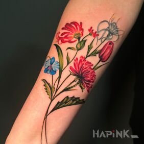 Tattoo Colorful flowers from the field On the arm motif: floral style: realistic