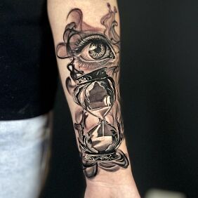 Tattoo Eye on the hourglass on the forearm motif: black and gray style: realistic