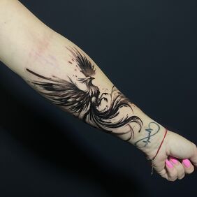 Tattoo Phoenix in gray on the forearm motif: black and gray style: graphic / illustrative