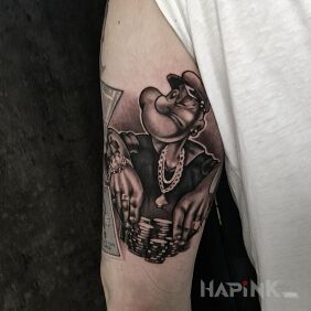 Tattoo Gangster Popeye on the bicep motif: black and gray style: cartoon / comic book