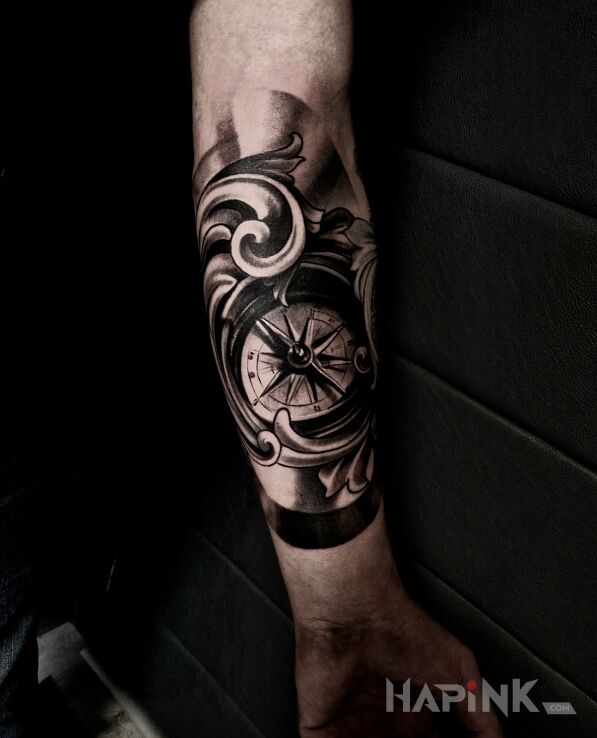 Tattoo Compass in black and gray motif and realistic style on the forearm