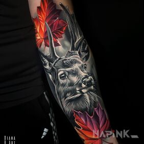 Tattoo Stag accompanied by colorful leaves On the arm motif: colorful style: realistic