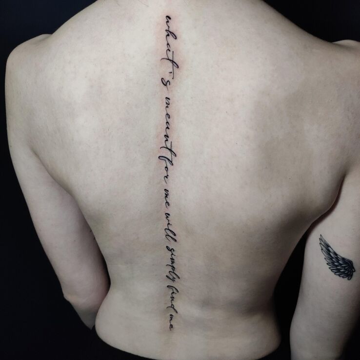 Tattoo Spine inscription in lettering motif and calligraphy style on the back