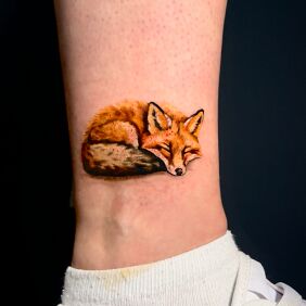 Tattoo Sleeping colorful fox near the ankle motif: colorful style: realistic