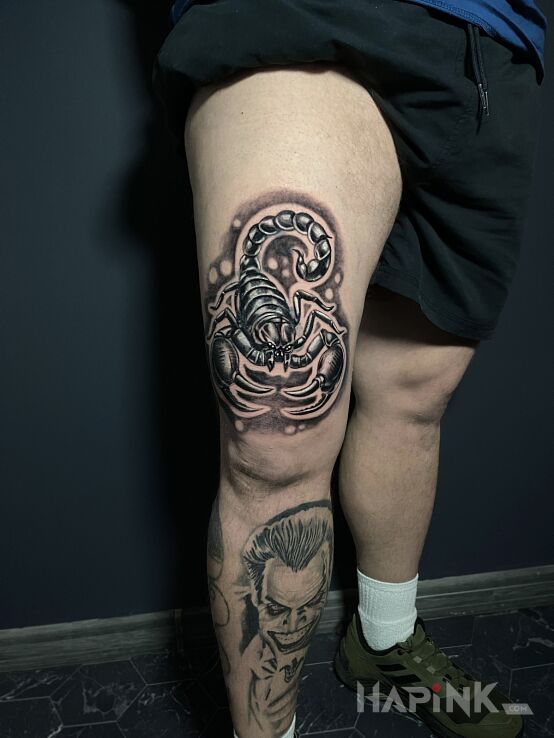Tattoo Scorpio in zodiac signs motif and realistic style on the leg