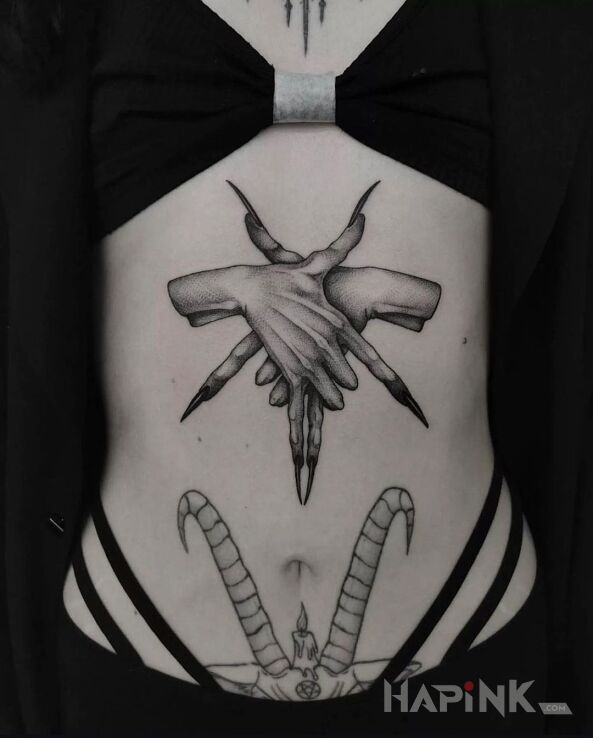 Tattoo Pentagram arranged with fingers in dark motif and realistic style on the stomach