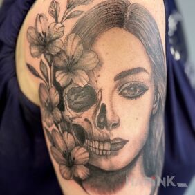 Tattoo "Life is a short moment." on the upper arm motif: faces style: realistic