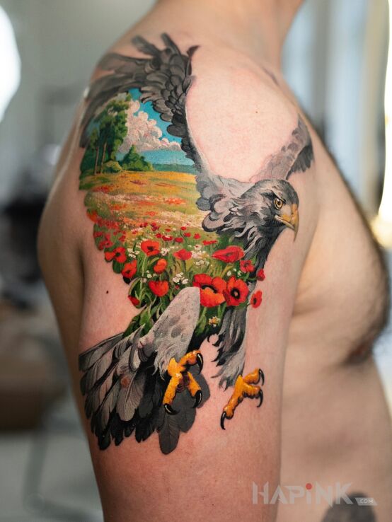 Tattoo Idyll captured in an eagle's body in colorful motif and realistic style On the arm