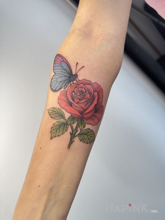 Tattoo Rose with butterfly in flowers motif and graphic / illustrative style On the arm
