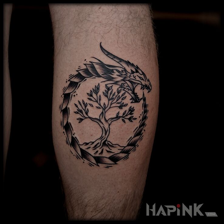 Tattoo Viking-style dragon and door in dragons motif and Celtic / Nordic style on the leg