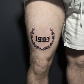 Tattoo Year of birth olive branch thigh on the thigh motif: black and gray style: graphic / illustrative