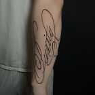 Inscription "purity" forearm