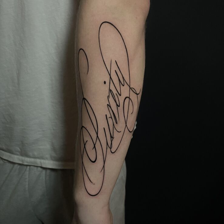 Tattoo Inscription "purity" forearm in black and gray motif and calligraphy style on the forearm