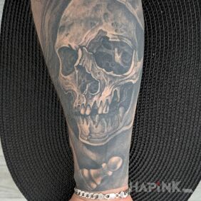 Tattoo Head in a hood On the arm motif: dark style: realistic