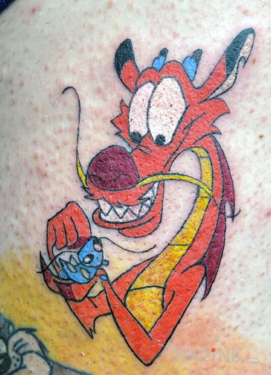 Tattoo Mushu in dragons motif and cartoon / comic book style on the leg