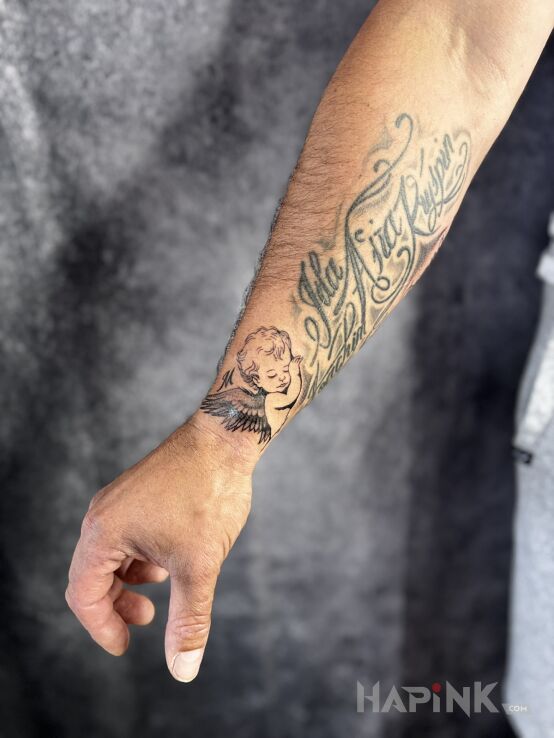 Tattoo Angel commemorating an unborn child in religious motif and graphic / illustrative style On the arm
