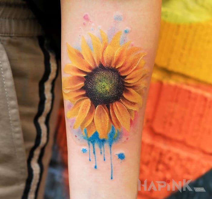 Tattoo Słonecznik in colorful motif and realistic style on the forearm
