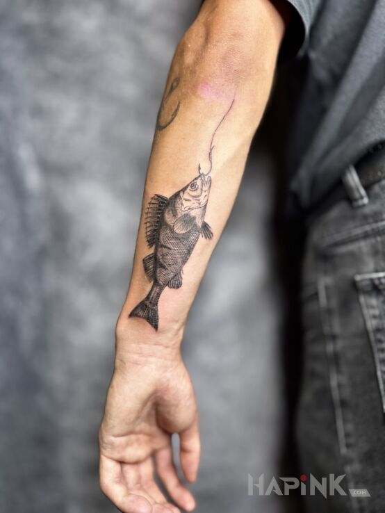 Tattoo Perch in black and gray motif and engravings / gravure style on the forearm