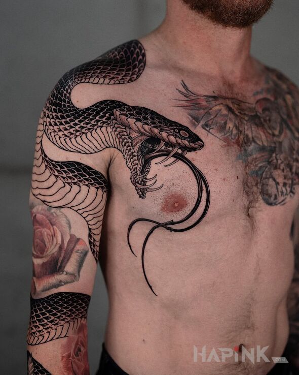 Tattoo Dangerous river snake in black and gray motif and realistic style on the upper arm