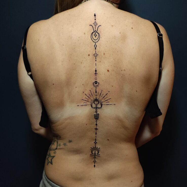 Tattoo Female spine tattoo in ornaments motif and contour / linework style on the back