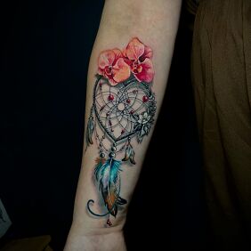 Tattoo Dreamcatcher with flowers and feathers On the arm motif: objects style: realistic