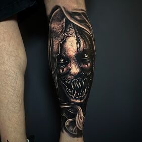 Tattoo Terrifying woman with monstrous teeth on the calf motif: faces style: realistic