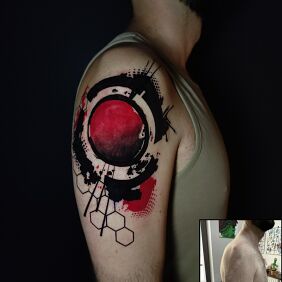 Tattoo Abstract black and red geometry on shoulder scar On the arm motif: colorful style: abstract