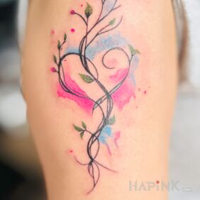 Tattoo Delicate watercolor on the upper arm motif: colorful style: Watercolor