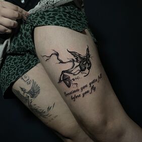 Tattoo Cocoon on a branch and a flying butterfly on the leg motif: lettering style: calligraphy