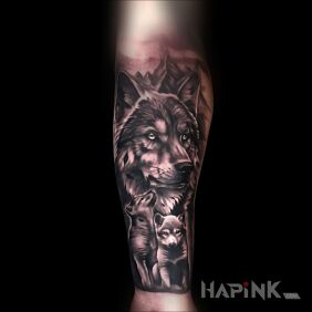 Tattoo Wolf with cubs on the forearm motif: black and gray style: realistic