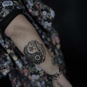 Tattoo Original Yin Yang on the forearm motif: black and gray style: graphic / illustrative
