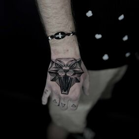 Tattoo Witcher Medallion On the arm motif: black and gray style: realistic