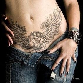 Tattoo Skull with wings on the stomach motif: skulls