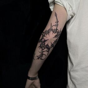 Tattoo Cybersigilism neotribal around the entire elbow on the elbow motif: black and gray