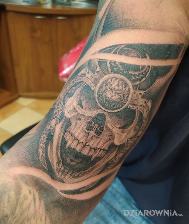 Tatuaż Starożytna czaszka z ominięciem bieli w motywie mroczne i stylu realistyczne na bicepsie