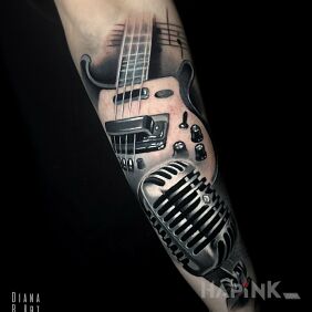 Tattoo Realistic music theme On the arm motif: black and gray style: realistic