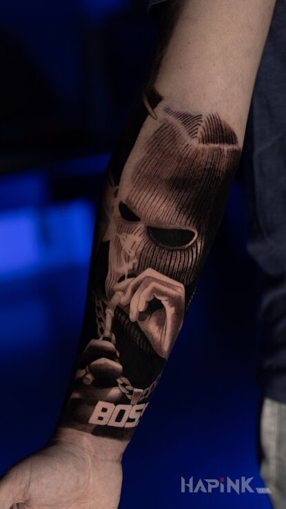 Tattoo Gangster smoking a pipe in characters motif and realistic style On the arm