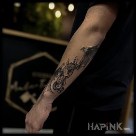 Tattoo Flying Gremlin on the forearm motif: black and gray