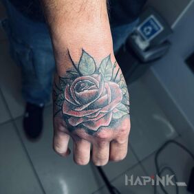 Tattoo Colorful rose on hand On the arm motif: flowers style: realistic