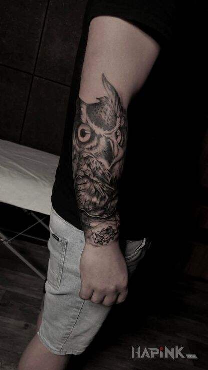 Tattoo Owl in animals motif and realistic style On the arm