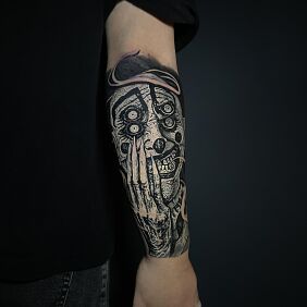 Tattoo Dark monstrous clown on the forearm motif: demons style: graphic / illustrative