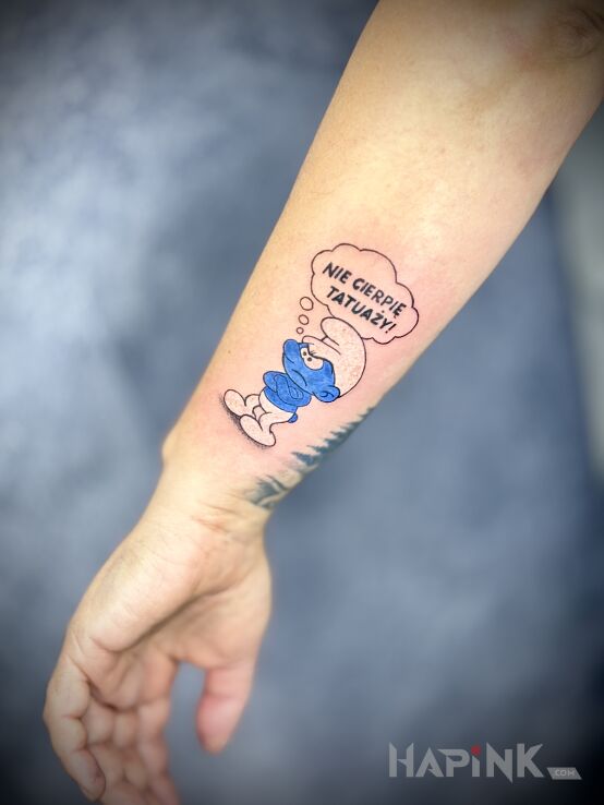 Tattoo Grumpy Smurf in characters motif and cartoon / comic book style On the arm