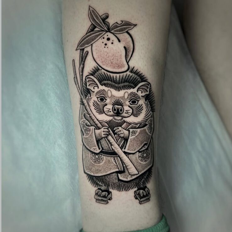 Tattoo Tanuki with a fruit branch in animals motif and graphic / illustrative style on the leg