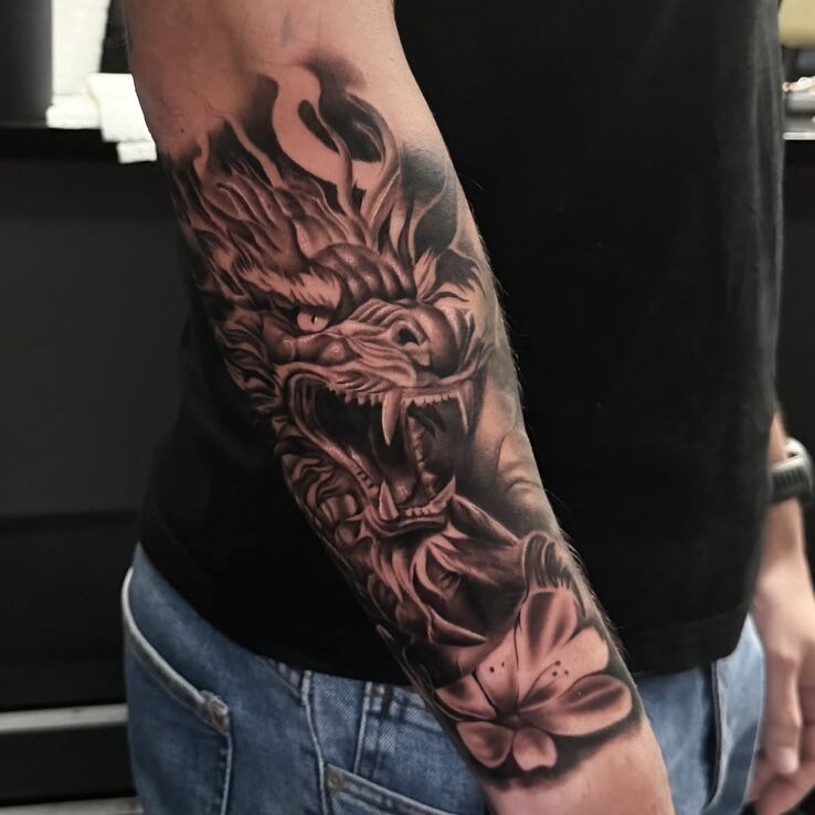 Tattoo Dragon - black & grey sleeve in sleeves motif and realistic style On the arm