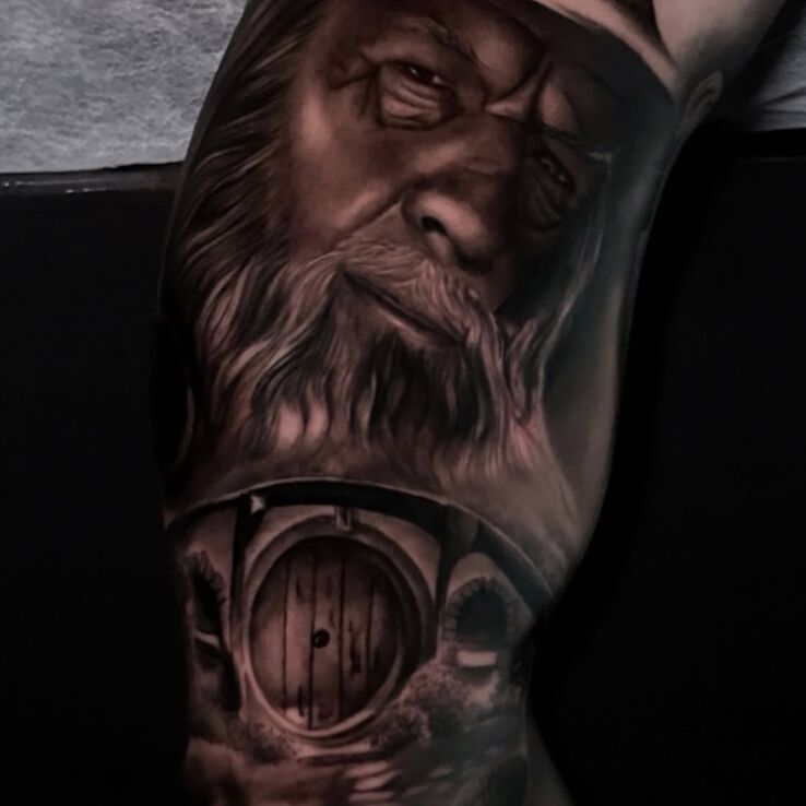 Tattoo Gandalf and the Shire - fantasy style tattoo in faces motif and realistic style On the arm